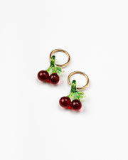 Earrings in the shape of two pairs of cherries, on a gold hoop, made from recycled glass.