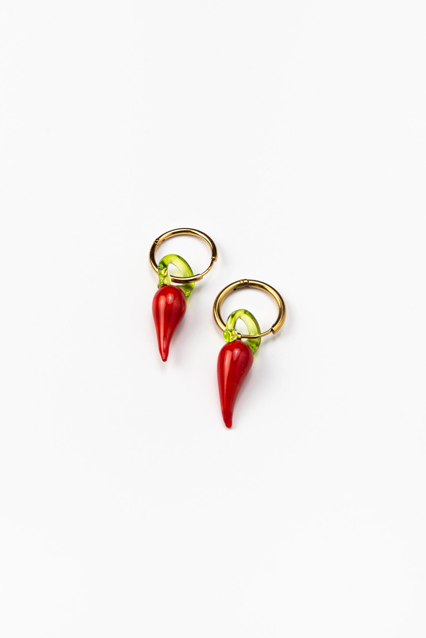 Gold hoop earrings with red chili pepper-shaped pendants made from recycled glass