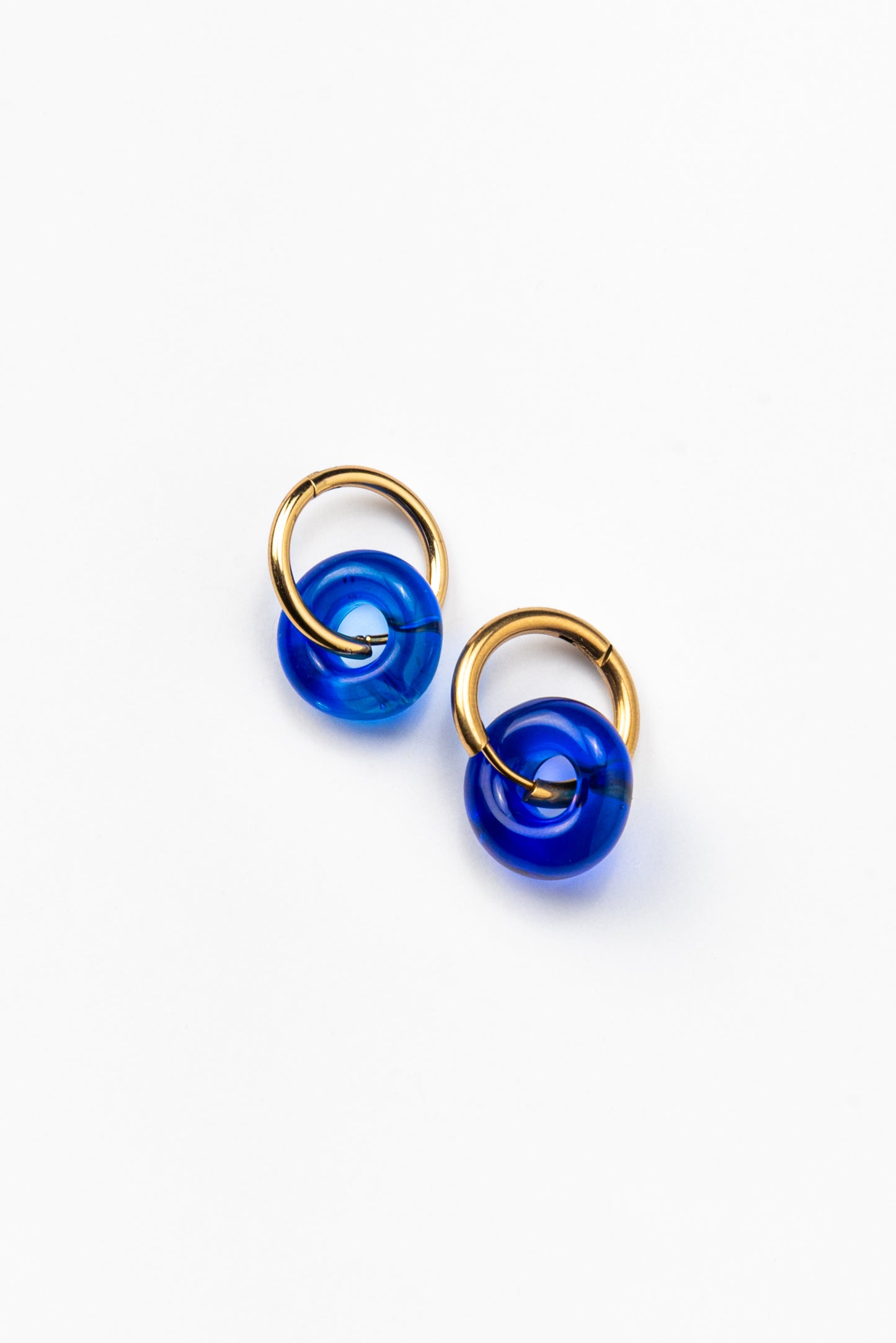 Deep blue hoop earrings on a base of gold stainless steel, made from recycled glass