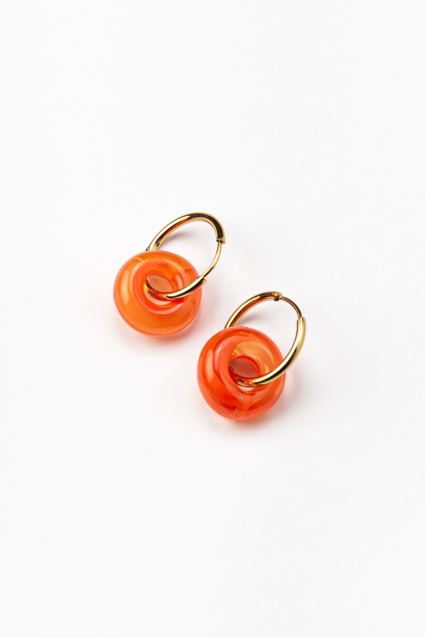 Orange hoop earrings on a base of gold stainless steel, made from recycled glass