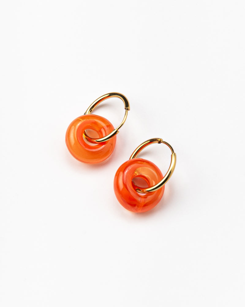 Orange hoop earrings on a base of gold stainless steel, made from recycled glass