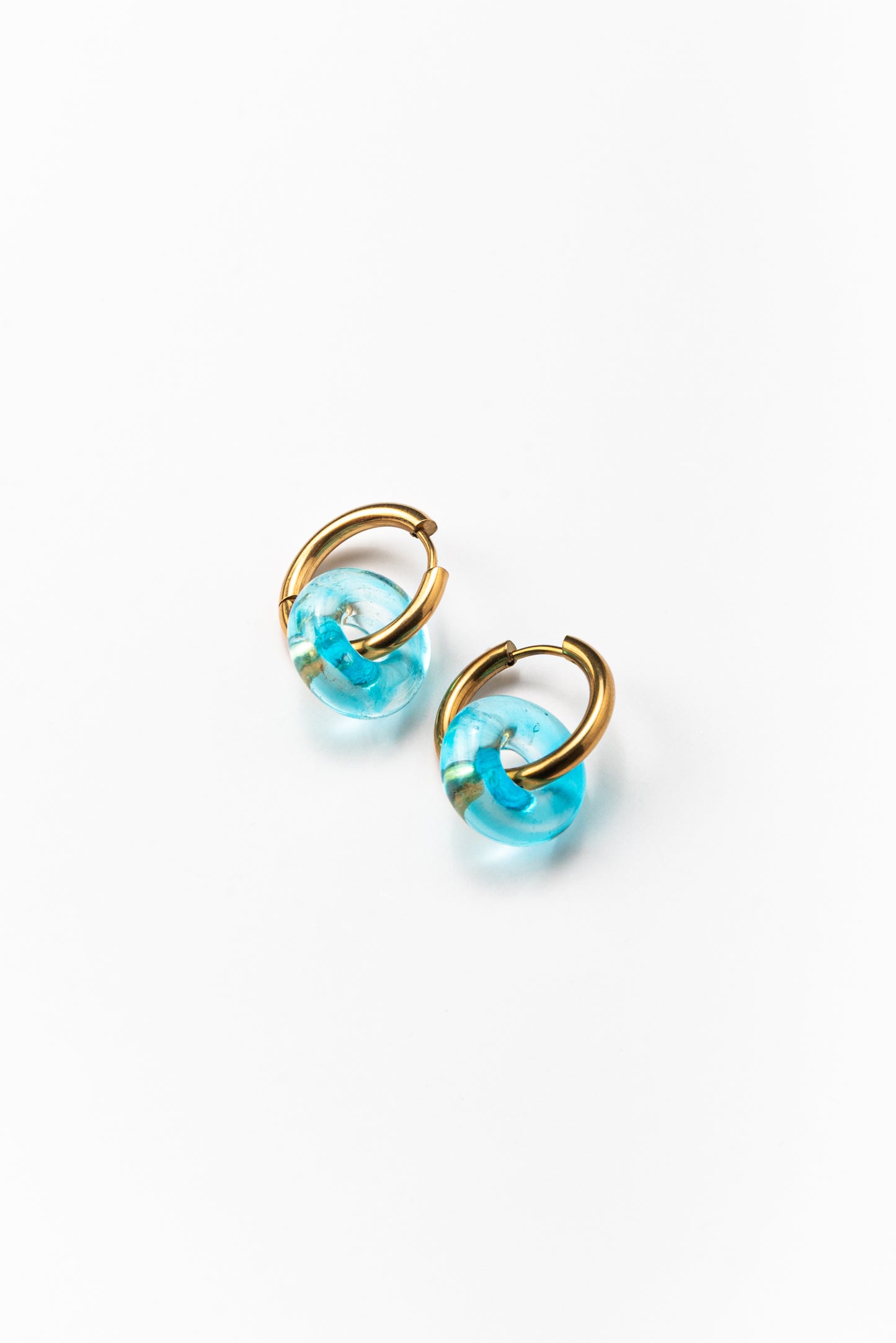 Lightblue hoop earrings on a base of gold stainless steel, made from recycled glass
