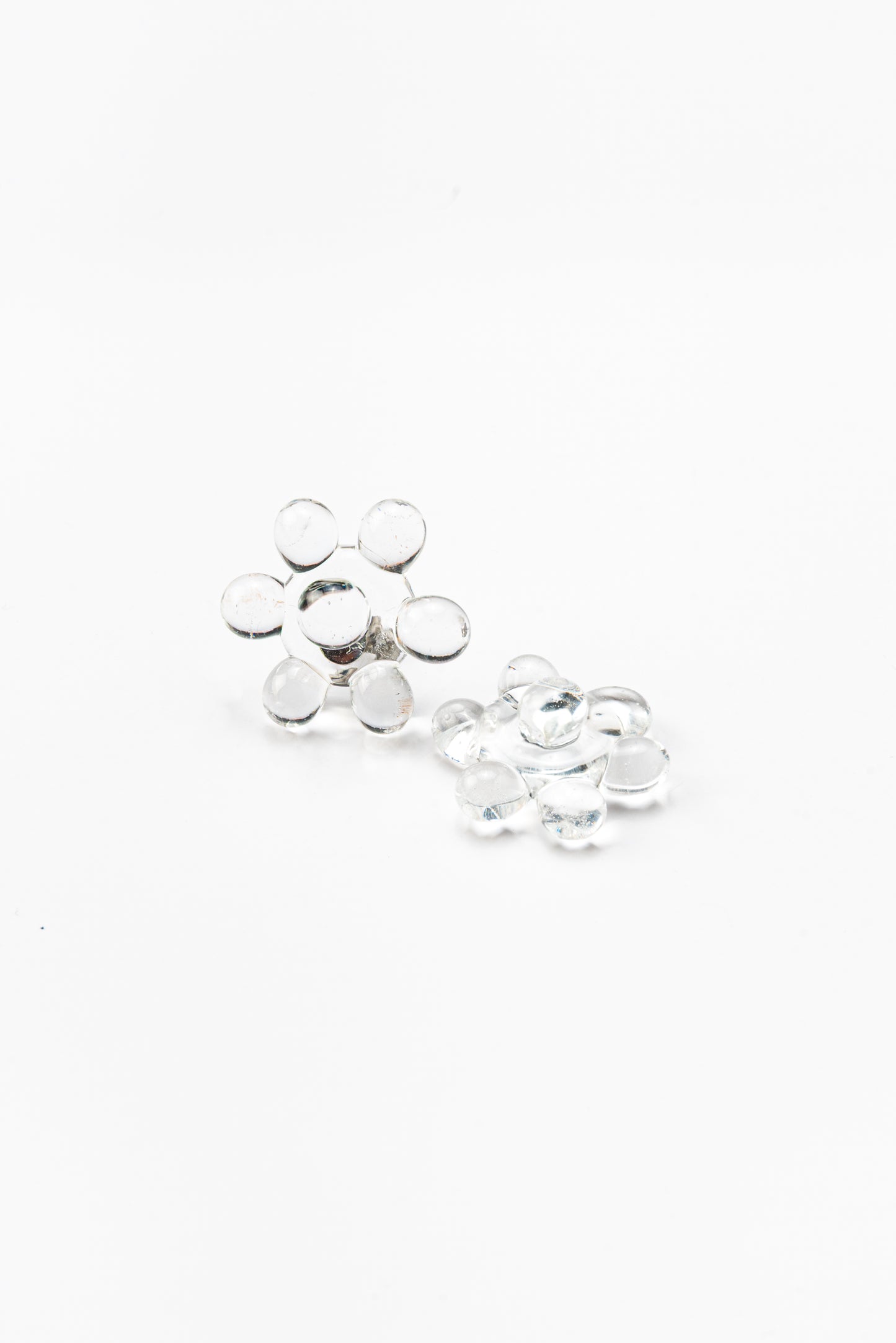 Pair of clear glass stud earrings arranged in a circular floral cluster design, made from recycled glass