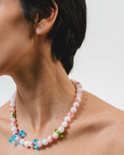 Necklace made of round pink-and-white gemstones, green river pearls and colorful recycled glass accents in blue and green, finished with a silver clasp