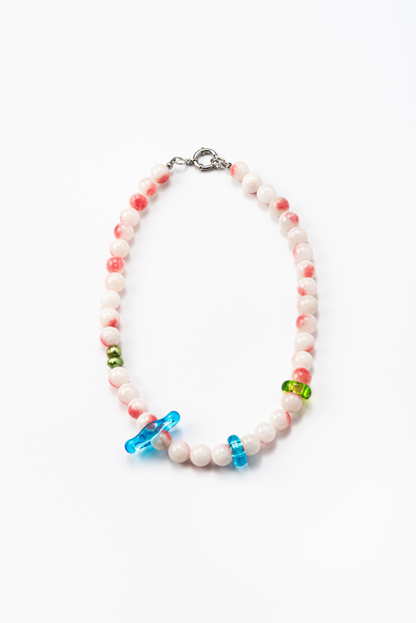 Necklace made of round pink-and-white gemstones, green river pearls and colorful recycled glass accents in blue and green, finished with a silver clasp