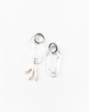 Clear dangle earrings with three pearls on one side, on a base of silver stainless steel, made from recycled glass
