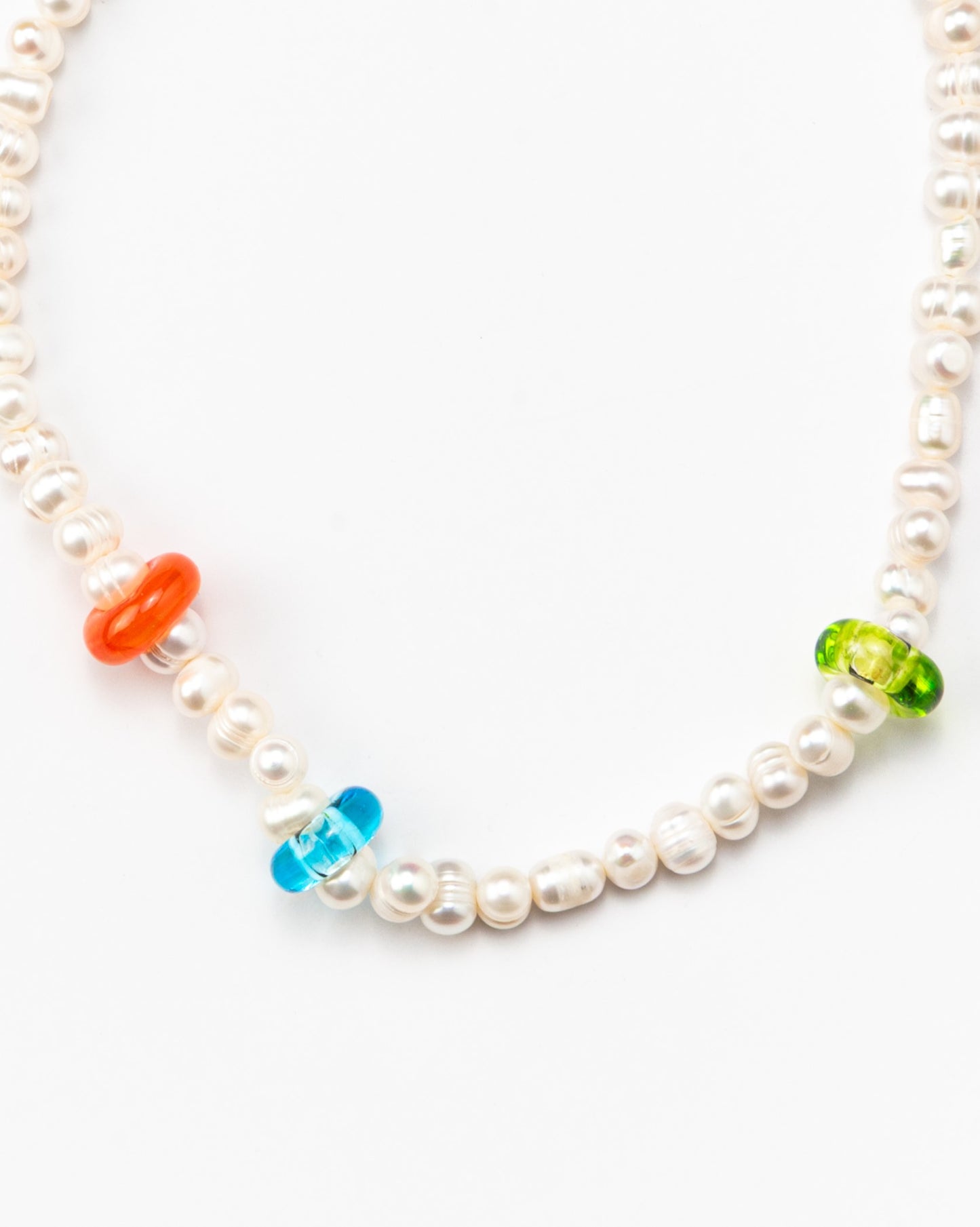 River pearl necklace with orange, blue, and green accents, in the form of a donut, made from recycled glass, and a gold toggle clasp