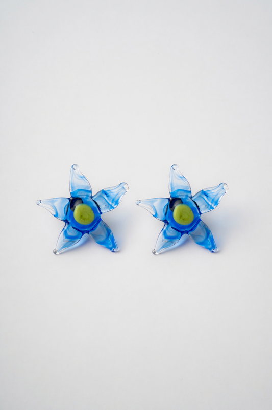 Pair of blue flower-shaped earrings on a white background
