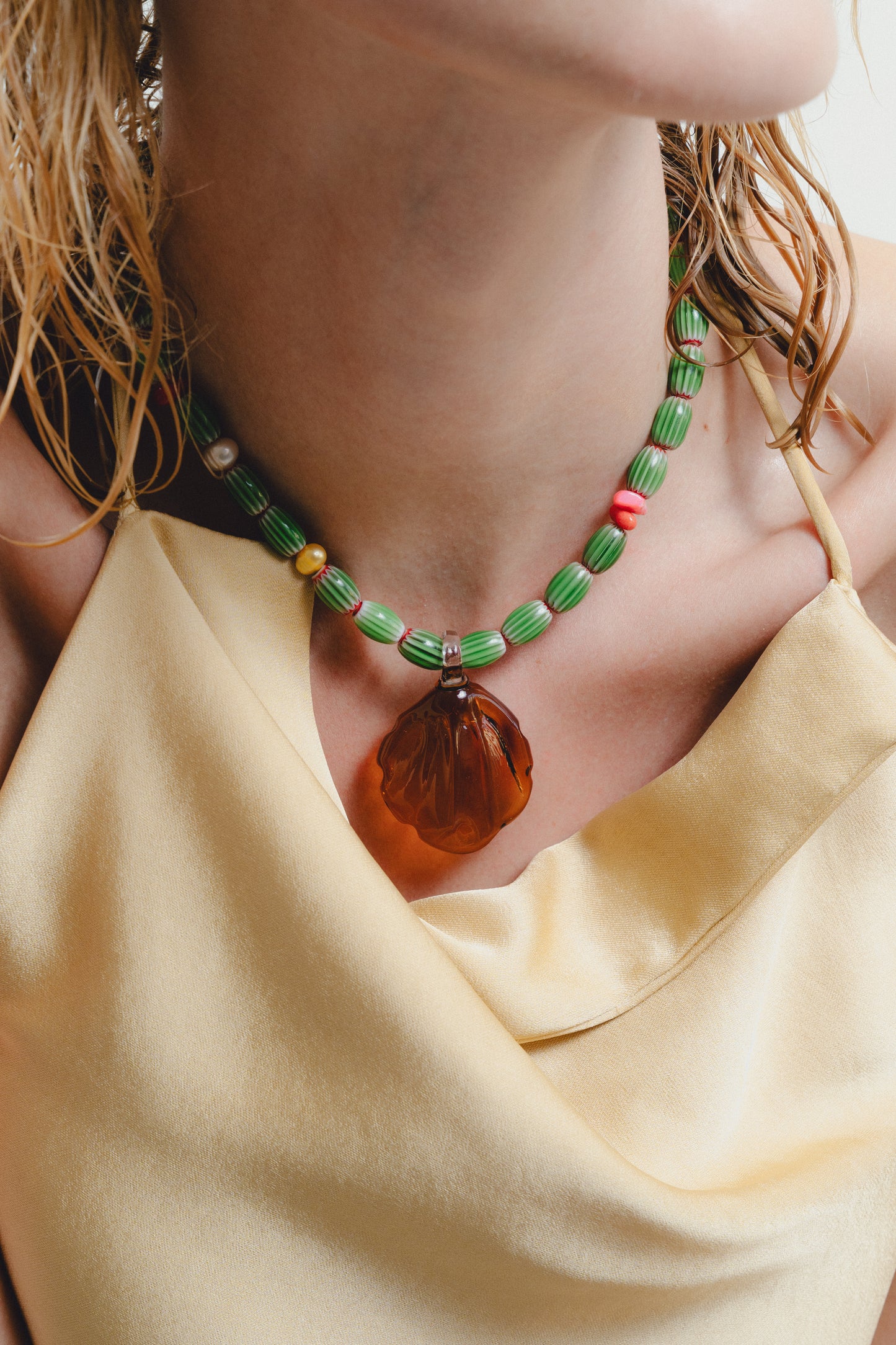 Handmade colorful necklace with a large amber pendant