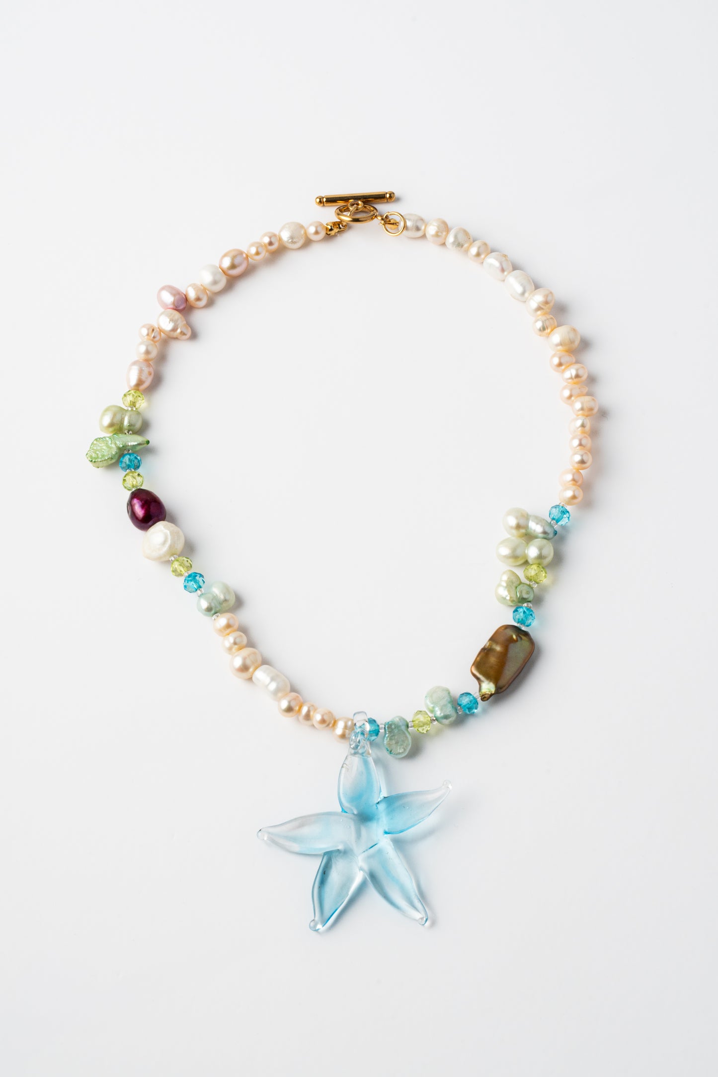 Necklace with starfish charm and multicolored beads on a white background