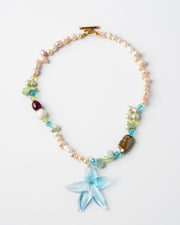 Necklace with starfish charm and multicolored beads on a white background