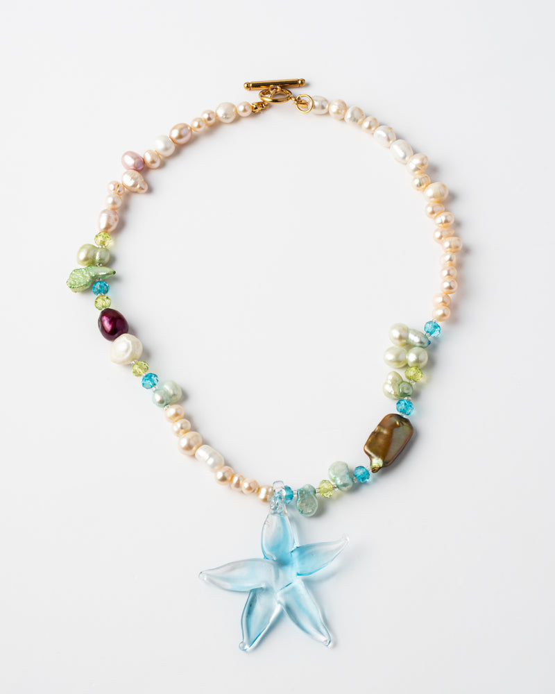 Necklace with starfish charm and multicolored beads on a white background
