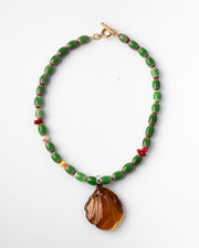 Colorful handmade necklace with green beads and a large amber pendant 