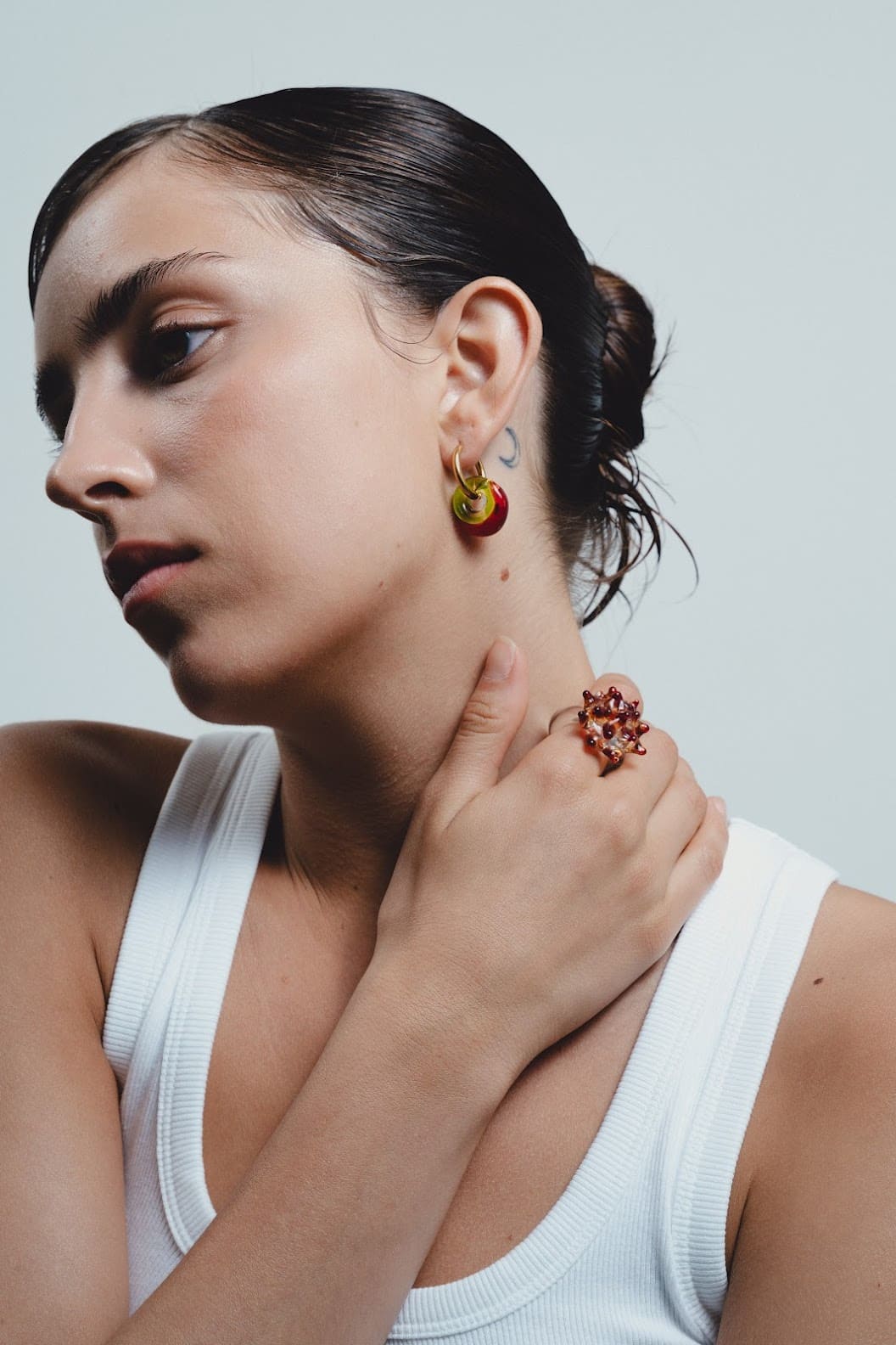 Woman wearing earrings made with recycle glass