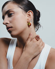 Woman wearing earrings made with recycle glass