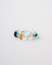Glass Ring with multicolored stones on a light gray background