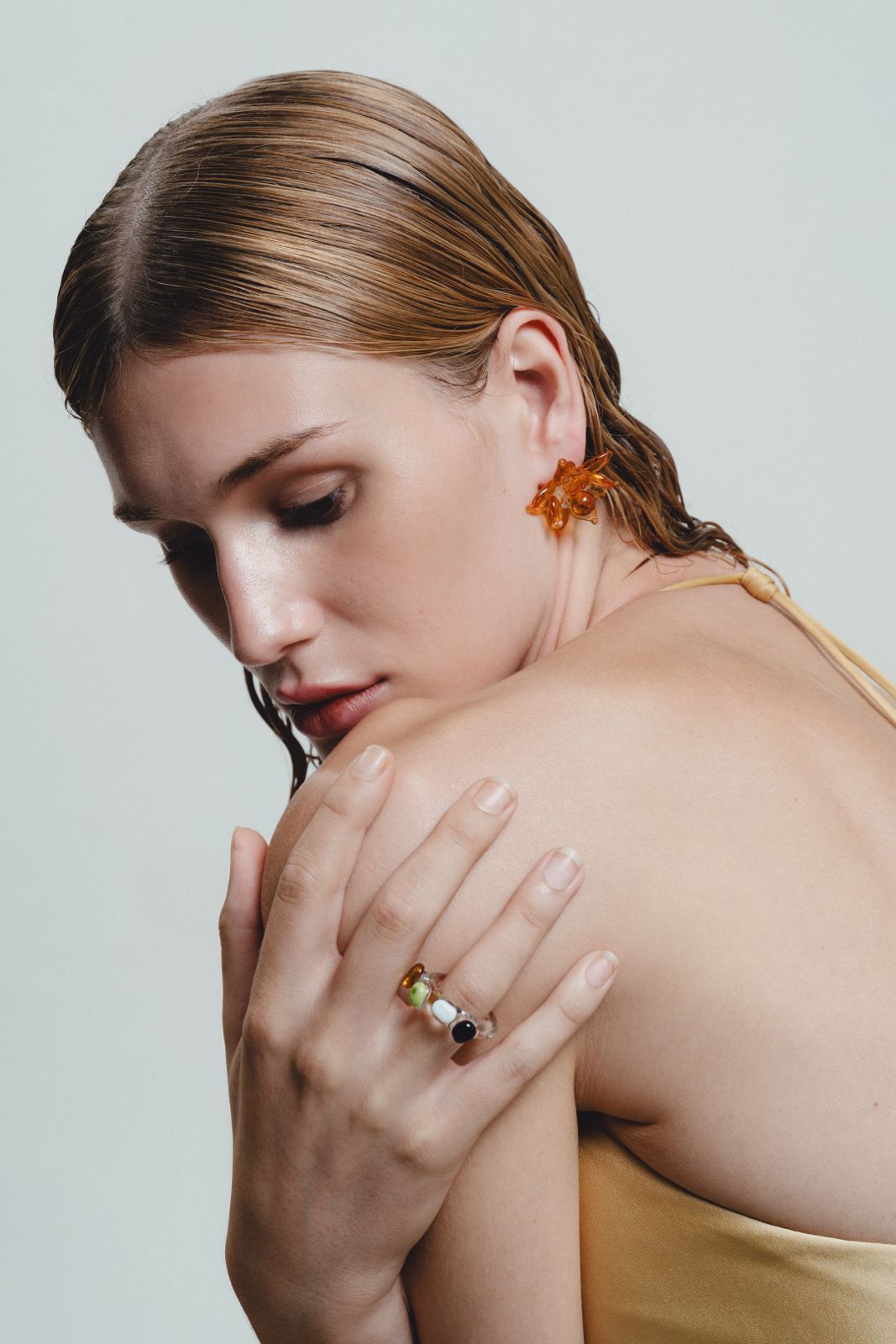 Glass Ring with multicolored stones on a light gray background