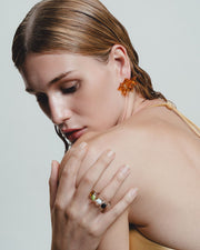 Glass Ring with multicolored stones on a light gray background