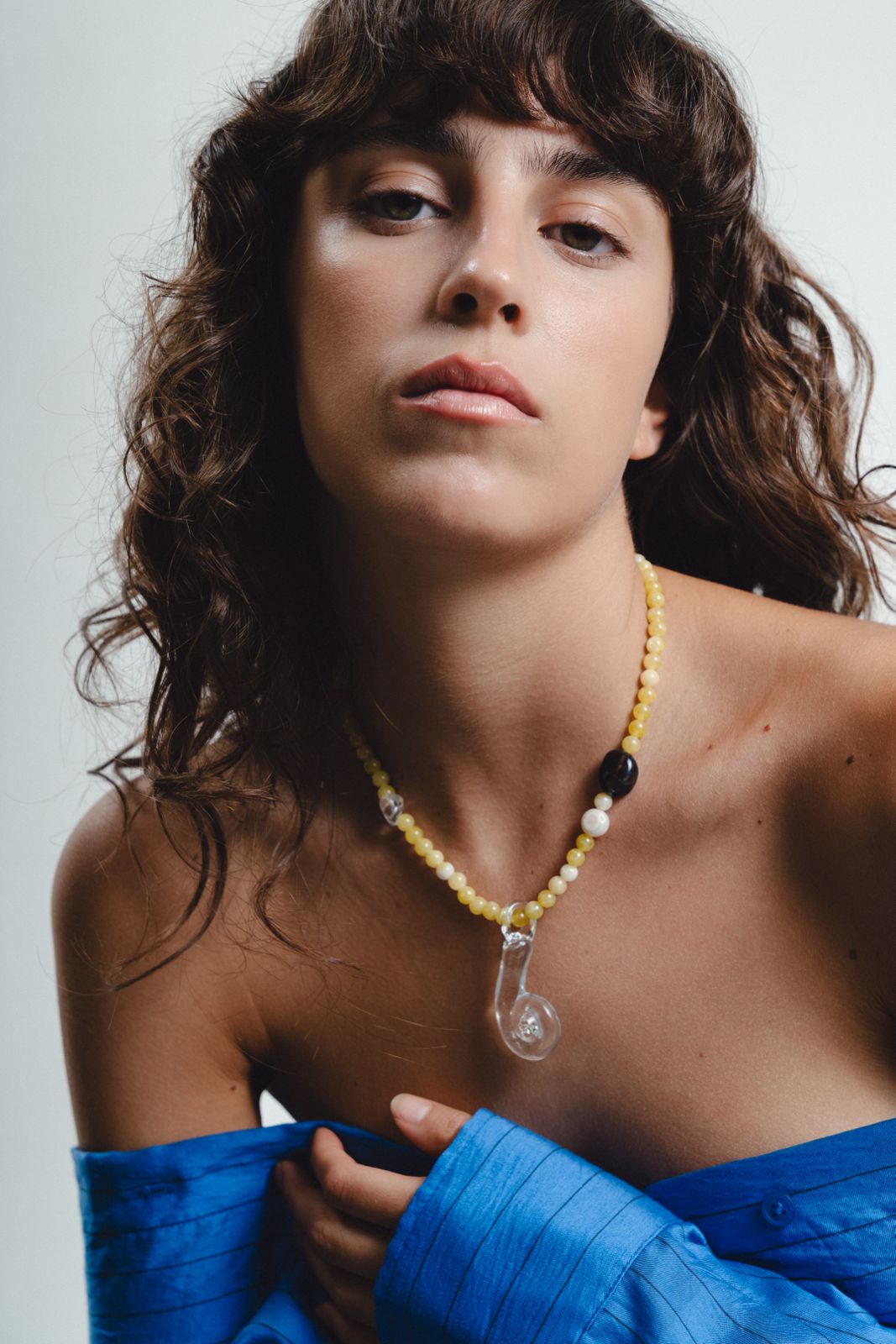 Yellow beaded necklace with clear glass pendant
