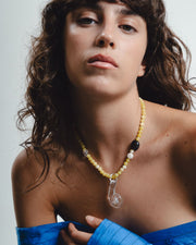 Yellow beaded necklace with clear glass pendant