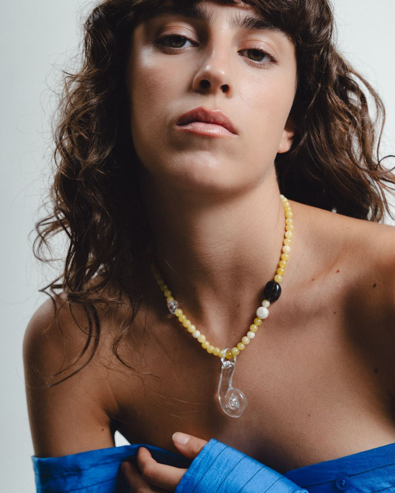 Yellow beaded necklace with clear glass pendant