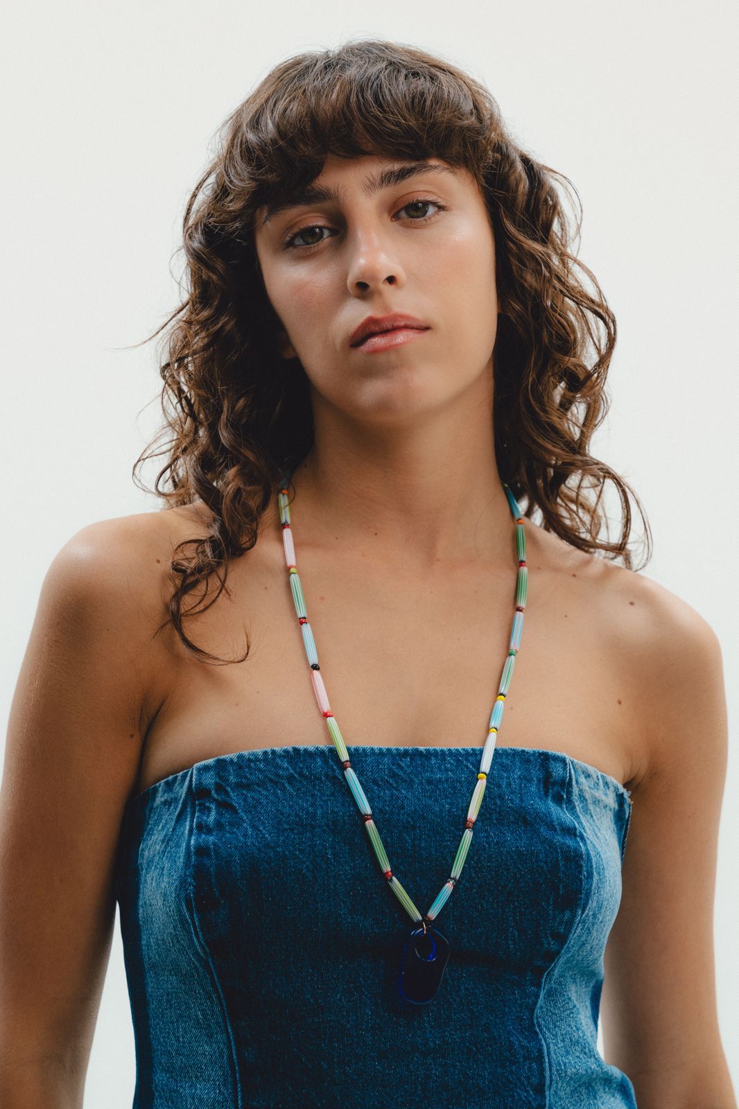 Colorful handmade  beaded necklace with a blue pendant 