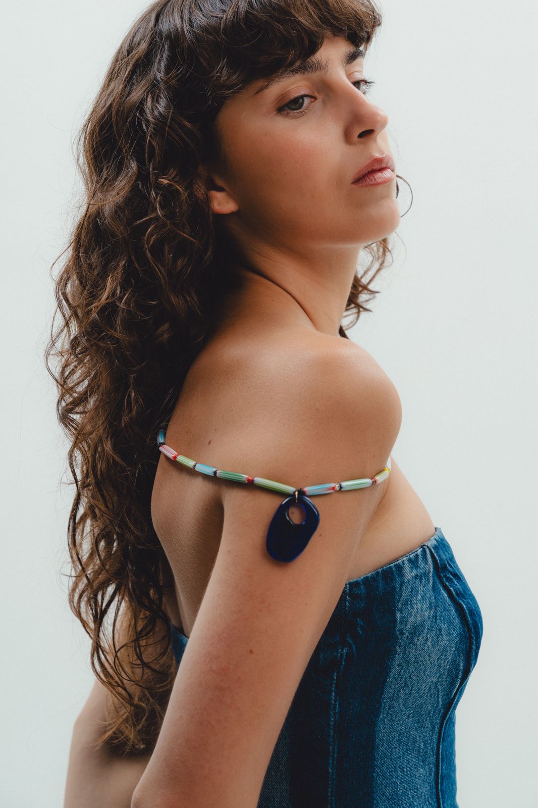 Colorful handmade  beaded necklace with a blue pendant 