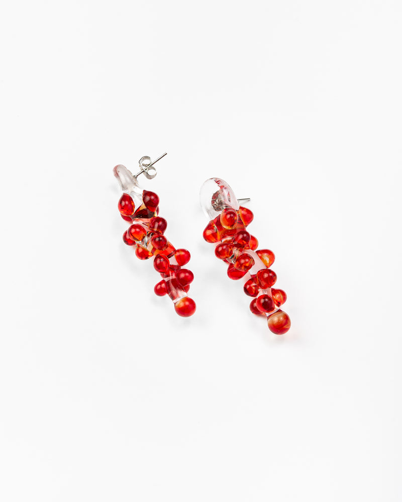 Dangle earrings with red sphere clusters and clear studs, made from recycled glass.