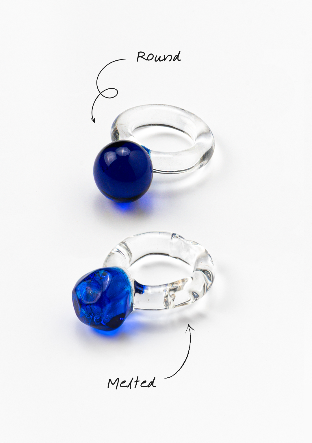 A clear Bolon ring with a dark blue-coloured sphere on top, made from recycled glass