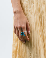 A clear Bolon ring with a sky blue-coloured sphere on top, handcrafted from recycled glass