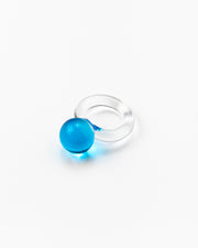 A clear Bolon ring with a sky blue-coloured sphere on top, handcrafted from recycled glass