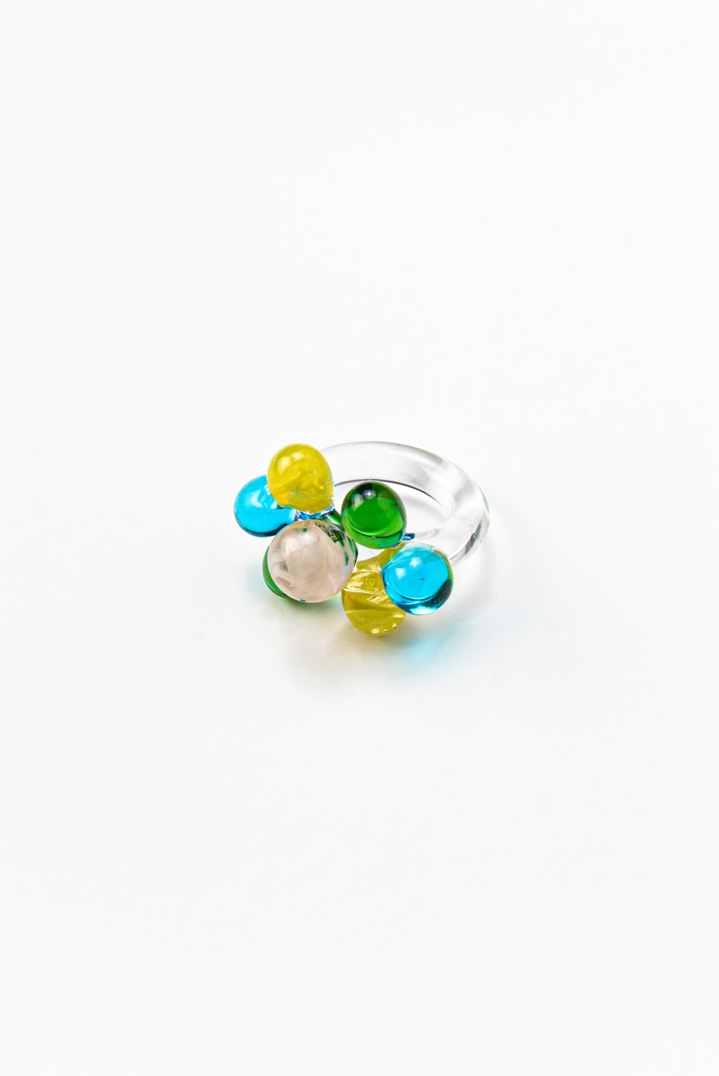 Clear ring with glass spheres, bubbles in green, yellow, turquoise, and peach tones, made from recycled glass.