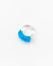 Clear ring with a bright turquoise textured glass detail on top, made from recycled glass.