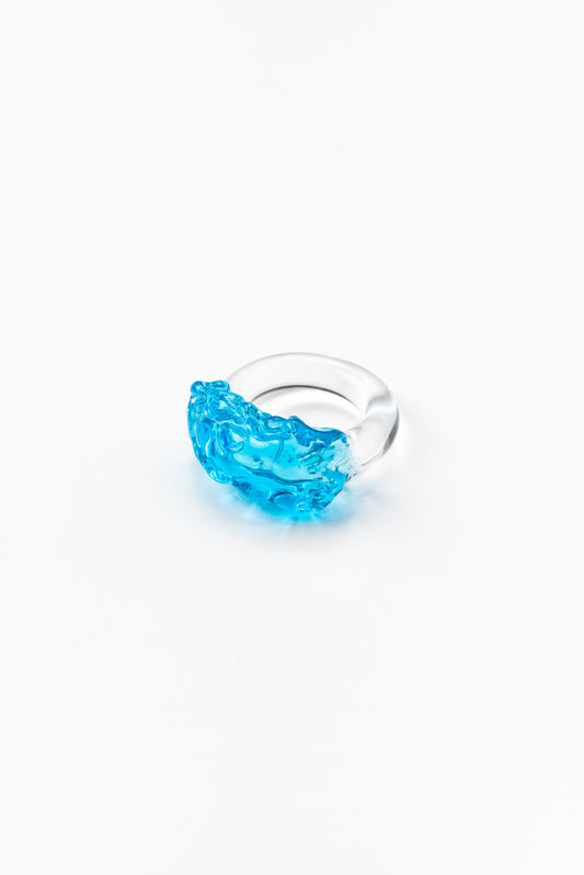 Clear ring with a turquoise textured glass detail on top, made from recycled glass.