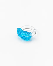 Clear ring with a turquoise textured glass detail on top, made from recycled glass.