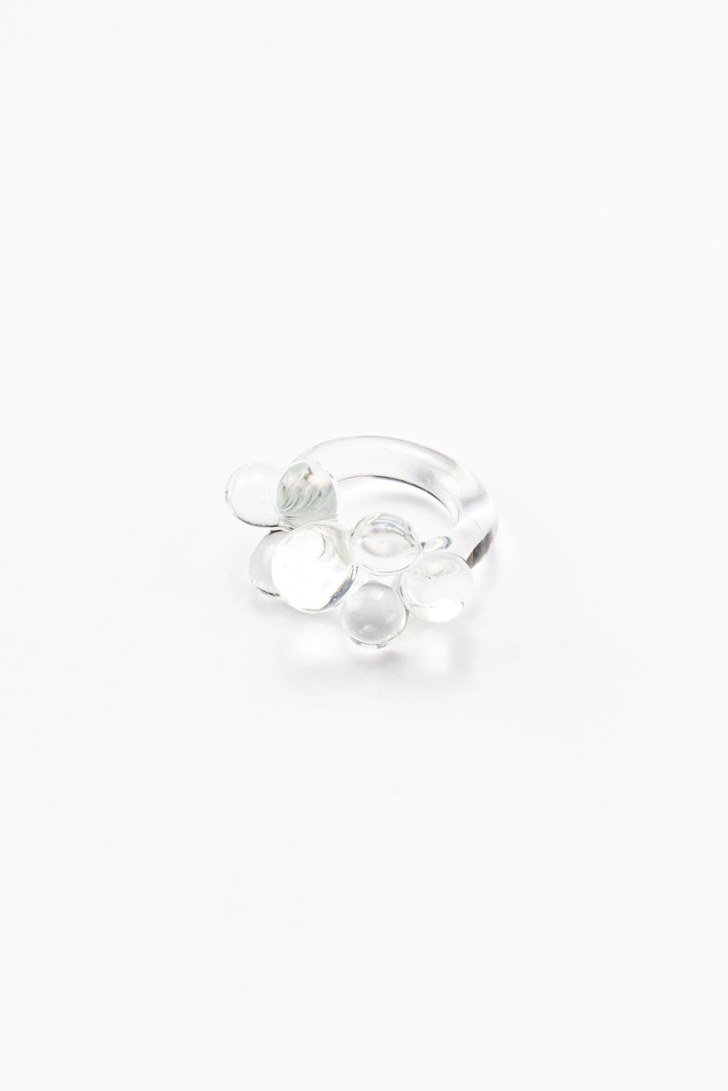 Clear ring featuring a cluster of small transparent glass spheres on top, made from recycled glass