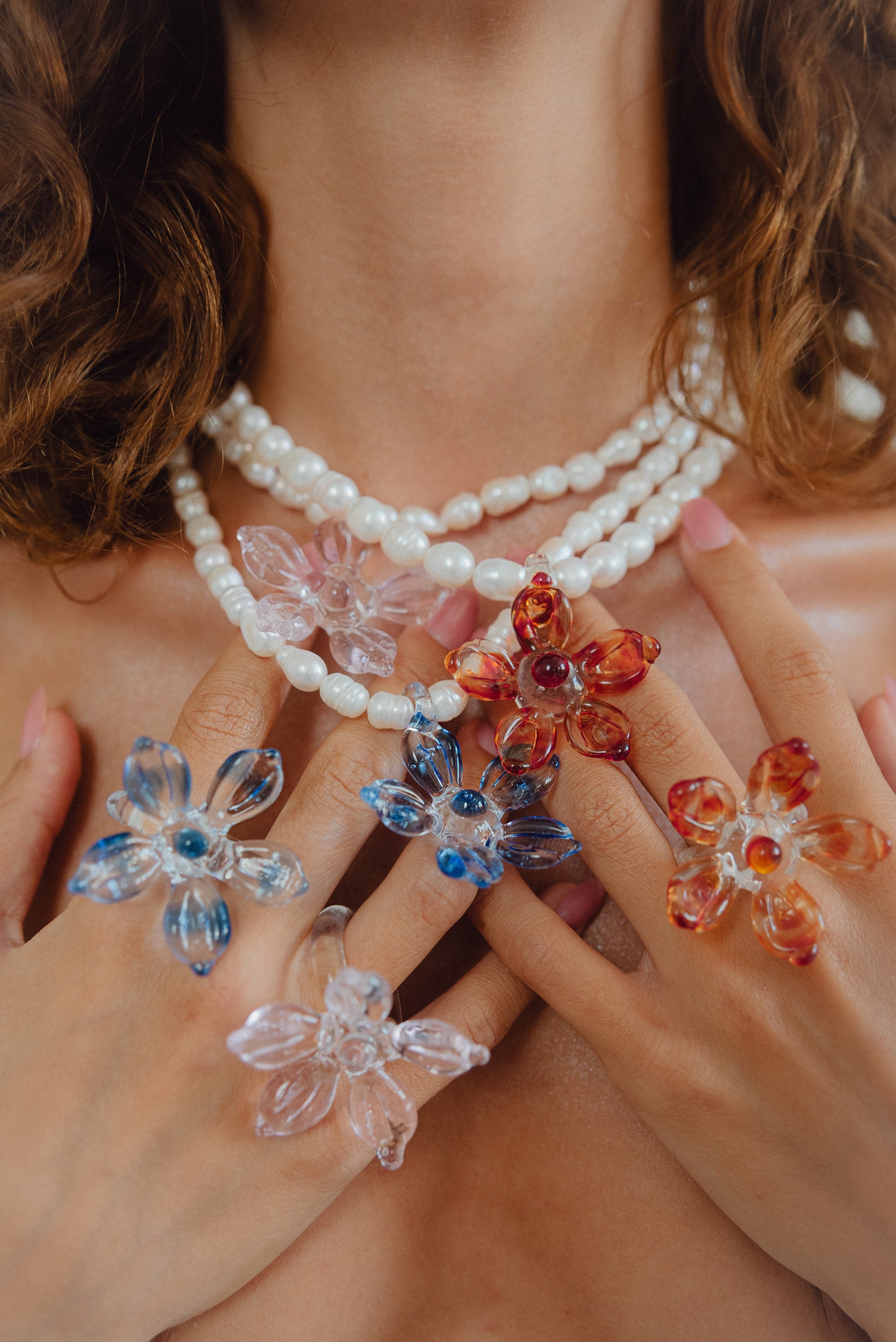 Rings featuring large pink, blue, and red flowers, made from recycled glass