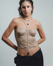 Woman wearing river pearl necklace